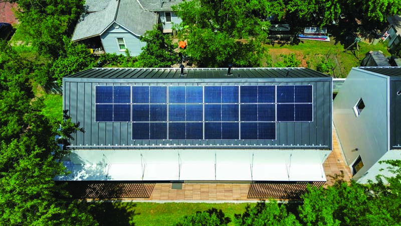 Designed and built by students in the University of Kansas School of Architecture & Design’s Studio 804 program, this 2,000-square-foot home showcases forward-thinking design in Lawrence, Kansas. Its sleek 20-gauge matte-black standing seam roof supports a solar array equipped with S-5! mounting attachments and snow retention—donated to help the students achieve their project goals in sustainable design.