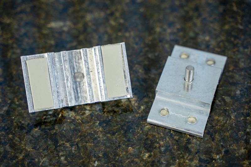 Figure 3: Factory-applied butyl tape encapsulated in the base of an S-5!®  SolarFoot metal roof attachment. (Photo courtesy of S-5!)